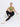 A female model wearing a greem sports bra with a high neckline and an open-back design with adjustable hook closures. She is also wearing black leggings and white sneakers.