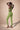Person wearing a green activewear yoga set