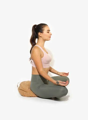 Person meditating on Shakti Warrior cork fabric meditation pillow with buckwheat filling