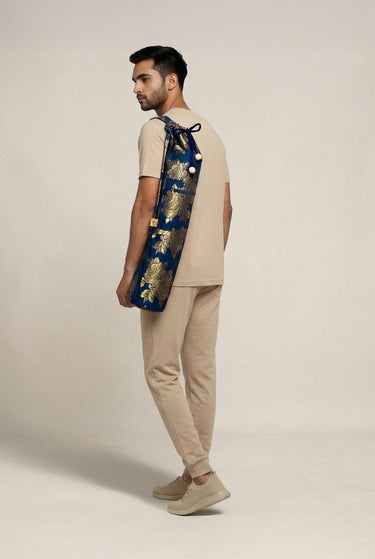 Man holding a yoga mat bag