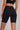 Woman wearing Shakti Warrior High-Rise AuraLux Biker Shorts in Black