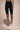 Woman wearing Shakti Warrior High-Rise AuraLux Biker Shorts in Black
