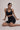 Woman wearing Shakti Warrior High-Rise AuraLux Biker Shorts in Black