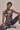 Woman wearing a floral sports bra and leggings set on a beige background