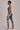 Woman wearing a floral sports bra and leggings set on a neutral background