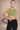 Woman wearing an adjustable green sports bra with high support
