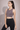 Woman wearing Shakti Warrior purple medium support BEAU sports bra