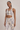 Woman in a animal print sports bra and matching leggings against a neutral background