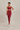 Woman wearing a red athletic outfit on a beige background