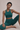 Woman in teal athletic wear sitting on a beige background