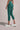 Person wearing Shakti Warrior High-waist AumLux Capri Leggings in a teal colour