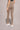 A woman wearing the High-waist AumLux Leggings in Brown
