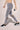 Woman wearing Shakti Warrior MotionWeave Leggings in Gray with mesha panels