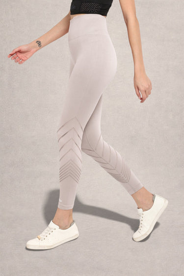 Person wearing Light gray leggings with laser cut on a neutral background