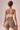 A woman wearing a white sports bra which has high support