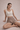 A woman wearing a white sports bra which has high support