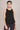 Woman wearing a Shakti Warrior black sleeveless workout top