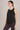 Woman wearing a Shakti Warrior motion core tank in black
