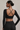 Woman wearing Shakti Warrior RE in black cross back crop top