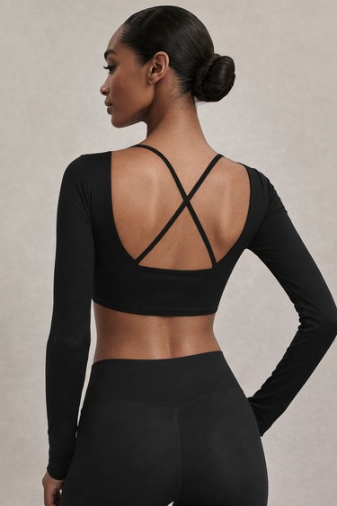 Woman wearing Shakti Warrior RE in black cross back crop top