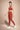Woman wearing Shakti Warrior IVY medium support strawberry red yoga set