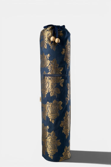 Yoga mat bag that is blue with gold floral patterns