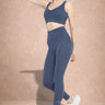 Side view Shakti Warrior AuraLux high support sports bra and leggings set in navy blue