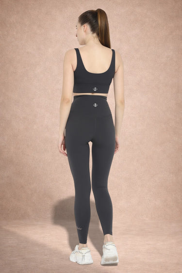 Back view of Shakti Warrior AuraLux high support sports bra and leggings set in charcoal gray