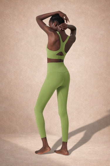 Person wearing a green activewear yoga set