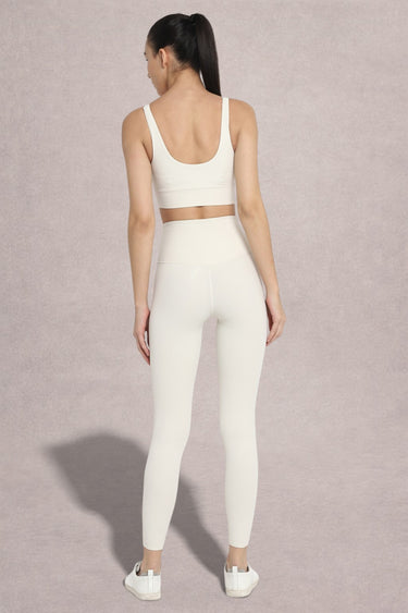 Back view of Shakti Warrior AuraLux high support sports bra and leggings set in white
