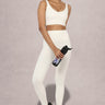 Side view of Shakti Warrior AuraLux high support sports bra and leggings set in white