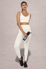 Side view of Shakti Warrior AuraLux high support sports bra and leggings set in white