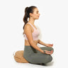 Person meditating on Shakti Warrior cork fabric meditation pillow with buckwheat filling