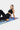 Woman in black athletic wear stretching on her cork roller