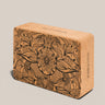 Cork yoga block with floral patterns on a beige background