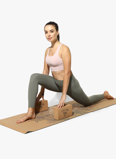 Woman practicing yoga on Shakti Warrior eco friendly 3mm cork elephant yoga mat