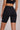 Woman wearing Shakti Warrior High-Rise AuraLux Biker Shorts in Black