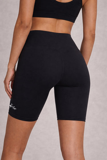 Woman wearing Shakti Warrior High-Rise AuraLux Biker Shorts in Black