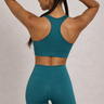 Woman in a teal sports bra and matching teal leggings