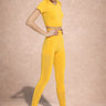 Woman wearing a yellow athletic outfit on a beige background