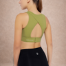 Woman wearing an adjustable green sports bra with high support