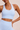 Woman wearing a high support ribbed light blue sports bra and matching shorts set