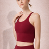 Woman wearing Shakti Warrior red medium support sports bra