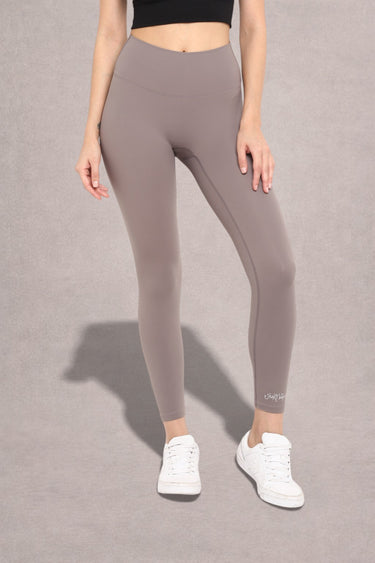 Woman wearing second skin fitted gray leggings