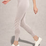 Person wearing Light gray leggings with laser cut on a neutral background