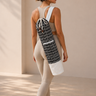 Woman carrying a shakti warrior yoga mat bag for her yoga mat