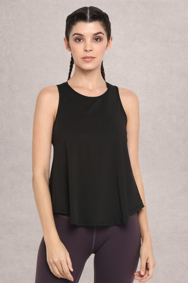 Woman wearing a Shakti Warrior black sleeveless workout top