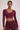 Woman wearing Shakti Warrior RE in burgundy cross back crop top