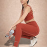 Woman wearing Shakti Warrior IVY medium support strawberry red yoga set